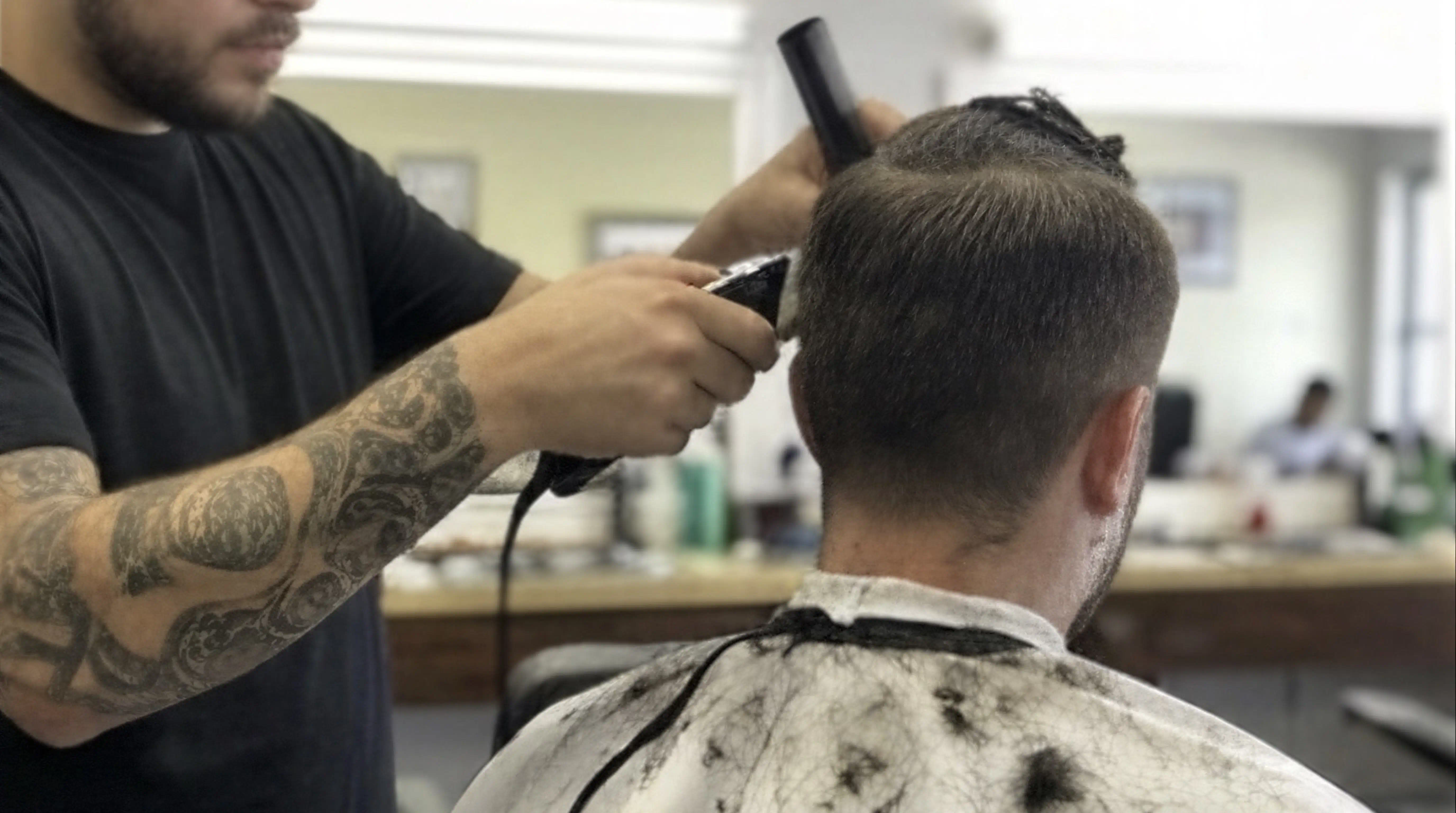 Before AI enhancement: Harshly lit amateur barbershop interior snapshot